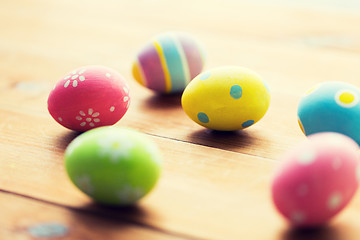 Image showing close up of colored easter eggs on wooden surface