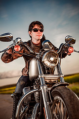 Image showing Biker girl on a motorcycle