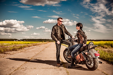 Image showing Bikers couple stands on the road