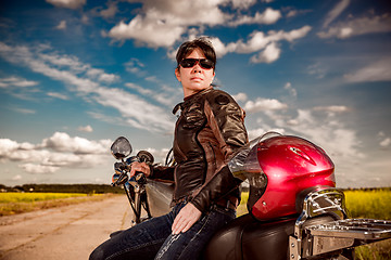 Image showing Biker girl on a motorcycle