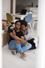 Image showing African American couple relaxing in new house