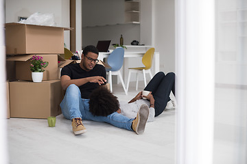 Image showing African American couple relaxing in new house