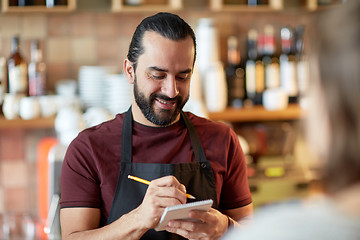 Image showing man or waiter serving customer at bar