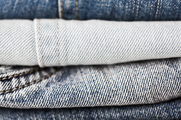 Image showing close up of denim clothes or jeans pile