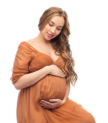 Image showing happy pregnant woman touching her big belly