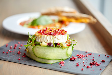 Image showing goat cheese salad with vegetables at restaurant