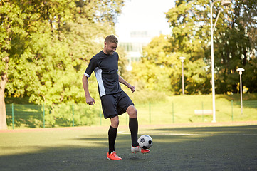 Image showing soccer player playing with ball on field