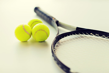 Image showing close up of tennis racket with balls