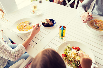 Image showing close up of family having dinner at restaurant 