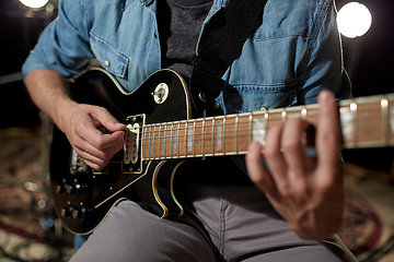 Image showing man playing guitar at studio rehearsal