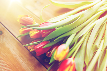 Image showing close up of tulip flowers on wooden table