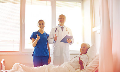 Image showing doctor and nurse visiting senior woman at hospital