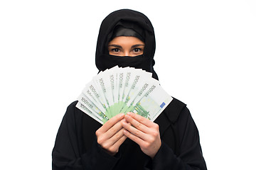 Image showing muslim woman in hijab with money over white