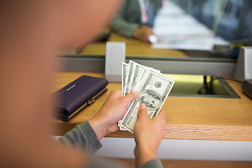 Image showing hands with money at bank or currency exchanger