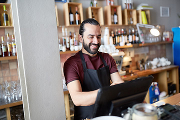 Image showing happy man or waiter at bar cashbox