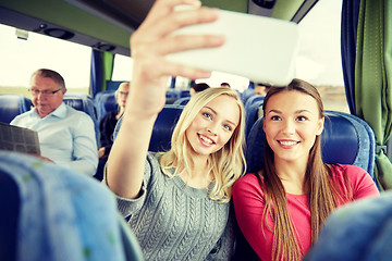 Image showing women taking selfie by smartphone in travel bus