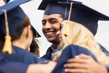 Image showing happy students or bachelors in mortar boards