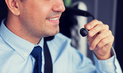 Image showing close up of happy bus driver talking to microphone