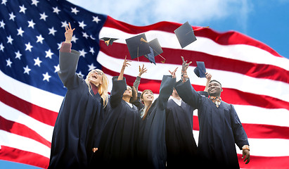 Image showing happy students throwing mortarboards up