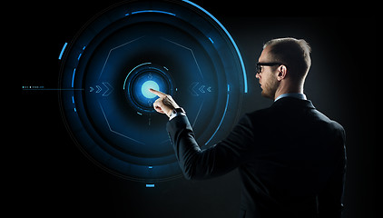 Image showing businessman pointing finger to virtual projection