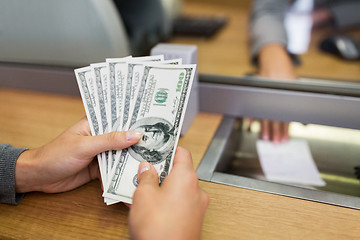 Image showing hands with money at bank office or exchanger