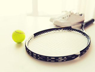 Image showing close up of tennis racket with ball and sneakers