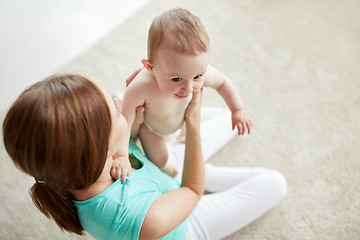 Image showing happy young mother with little baby at home