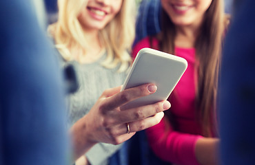 Image showing close up of women in travel bus with smartphone