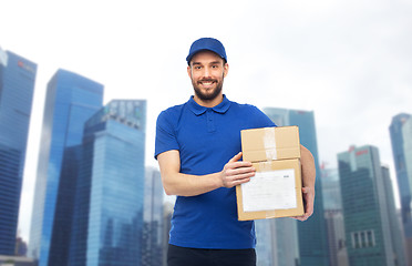 Image showing happy delivery man with parcel boxes