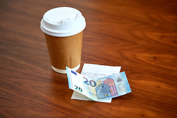 Image showing coffee in paper cup, bill and money on table