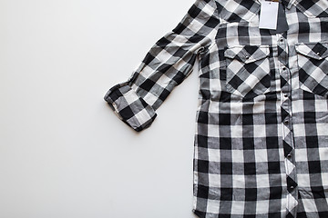 Image showing close up of checkered shirt on white background