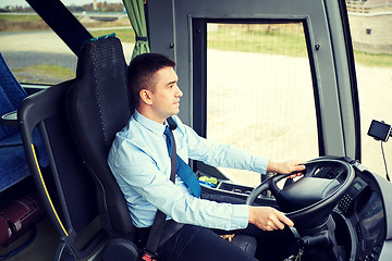 Image showing happy driver driving intercity bus