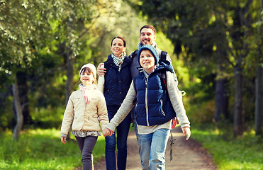 Image showing happy family with backpacks hiking