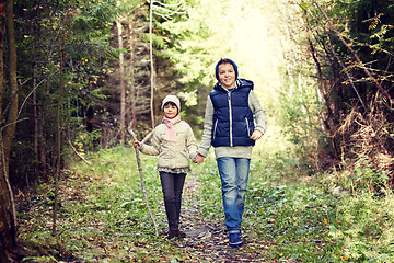 Image showing two happy kids walking along forest path