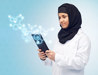 Image showing muslim female with tablet pc and chemical formula