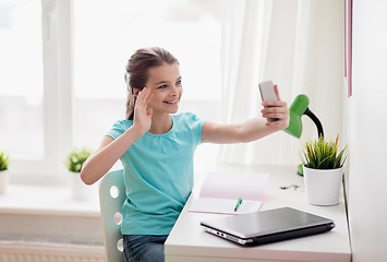 Image showing happy girl with smartphone taking selfie at home