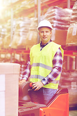 Image showing man on forklift loading boxes at warehouse