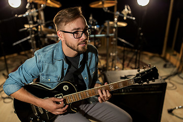 Image showing man playing guitar at studio rehearsal