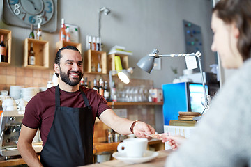 Image showing man or waiter serving customer at coffee shop