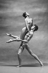 Image showing Couple of ballet dancers posing over gray background