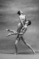 Image showing Couple of ballet dancers posing over gray background