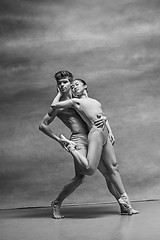 Image showing Couple of ballet dancers posing over gray background