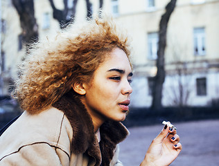 Image showing young pretty girl teenage outside smoking cigarette close up, looking like real junky, social issues concept