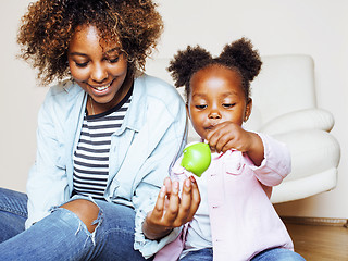 Image showing adorable sweet young afro-american mother with cute little daughter, hanging at home, having fun playing smiling, lifestyle people concept, happy smiling modern family 