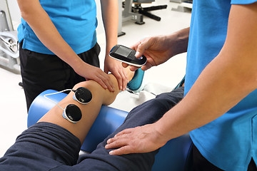 Image showing neurological rehabilitation Physiotherapy, ultrasound Physiotherapist doctor performs surgery on a patient's leg