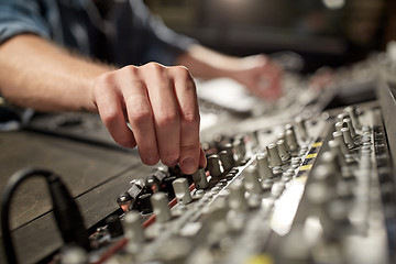 Image showing man using mixing console in music recording studio