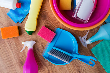 Image showing basin with cleaning stuff on wooden floor