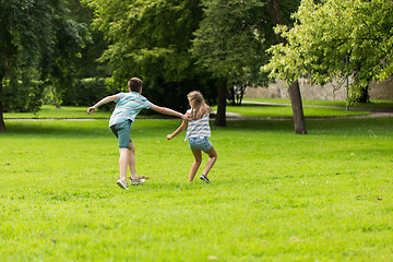 Image showing group of happy kids or friends playing outdoors