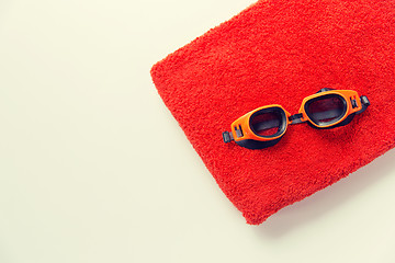 Image showing close up of swimming goggles and towel