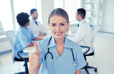 Image showing happy doctor over group of medics at hospital